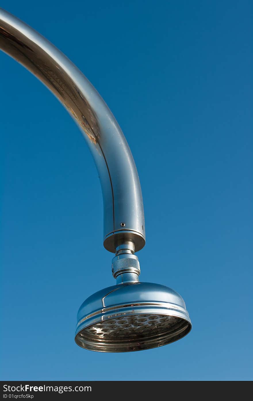 Outside shower head against a blue sky on beach resort by sea. Outside shower head against a blue sky on beach resort by sea