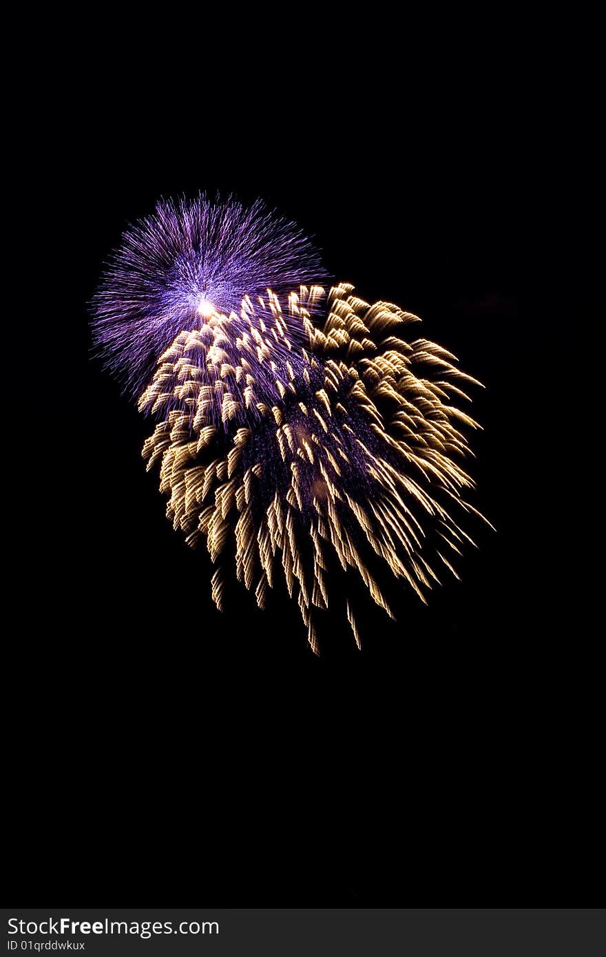 Blue and yellow firework at night