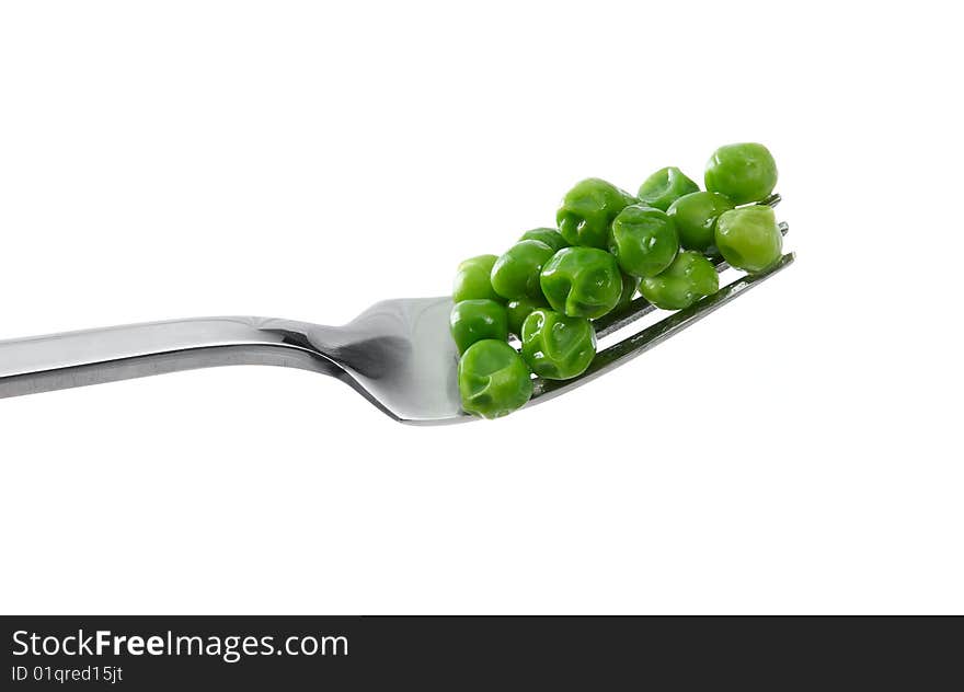 Peas on a fork on a white background. Peas on a fork on a white background