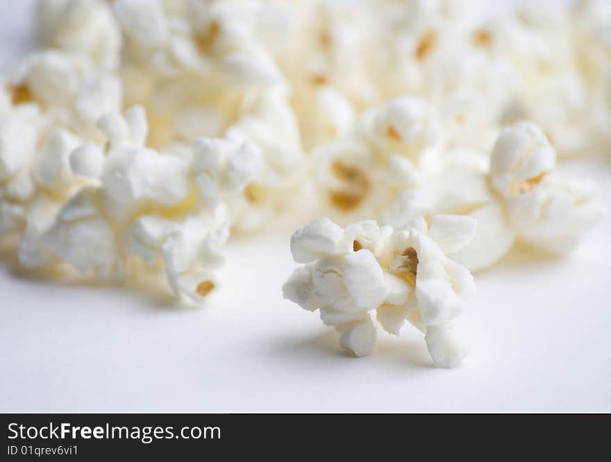 Popped popcorn on white background