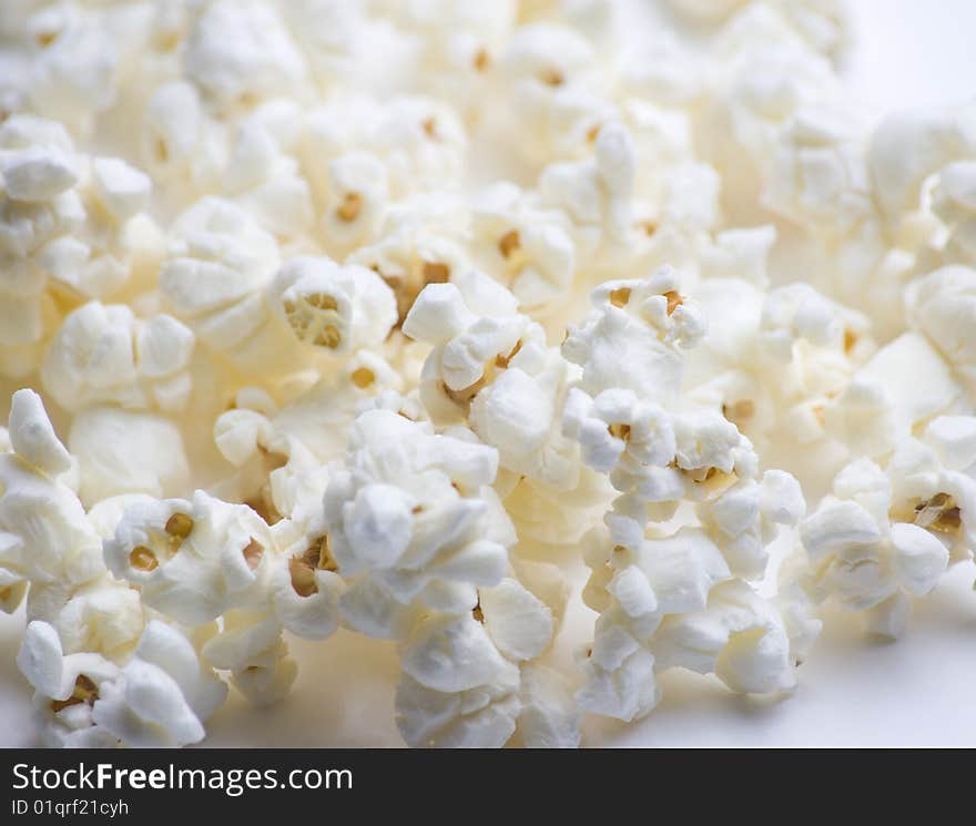 Popped popcorn on white background