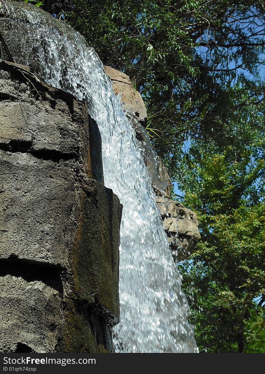 Crystal clear water tumbling over a rocky escarpment. Crystal clear water tumbling over a rocky escarpment