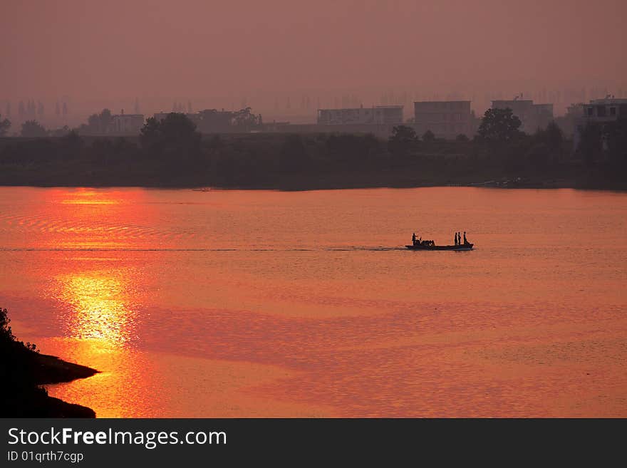 The river is golden at sunset. The river is golden at sunset