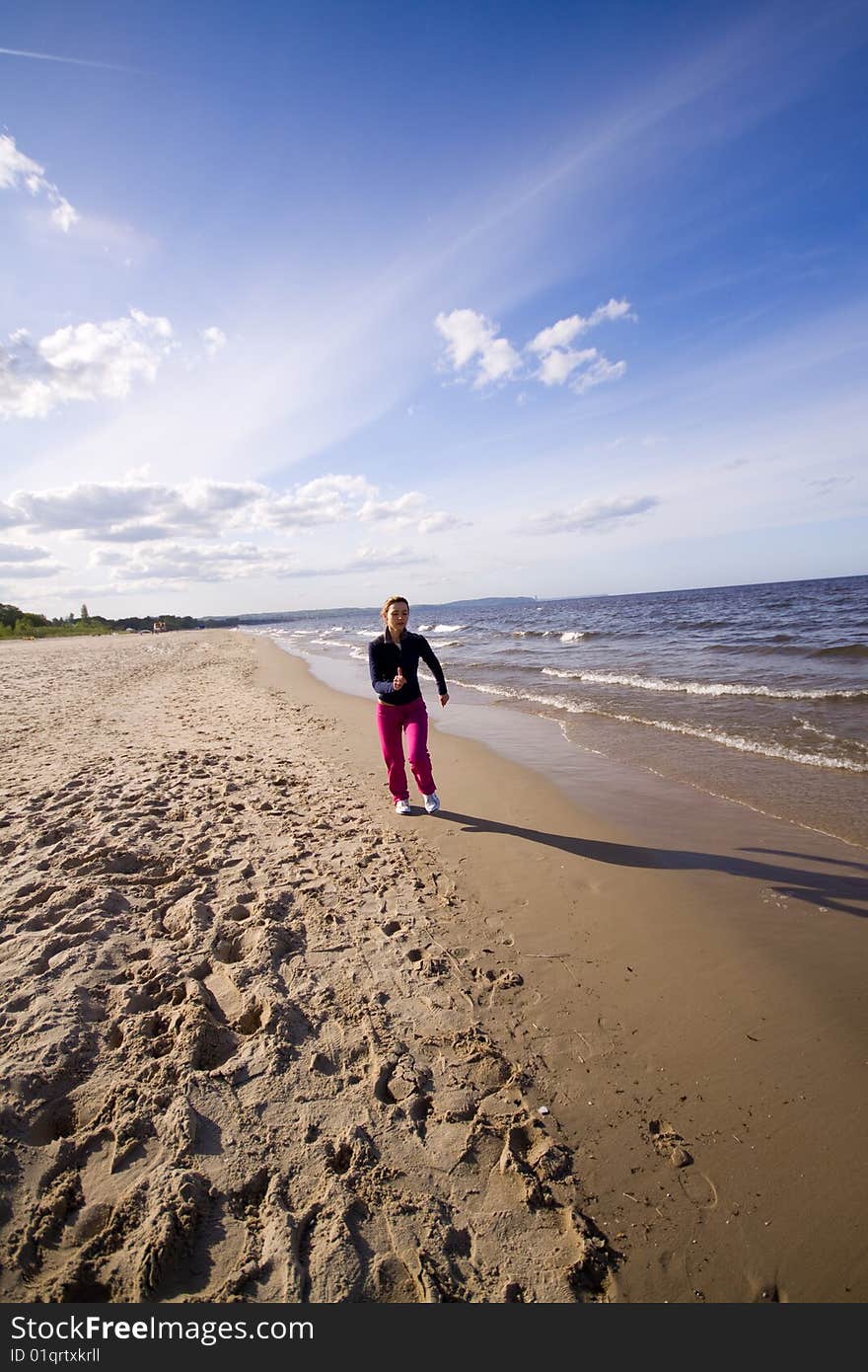 Active woman running on the beach. Active woman running on the beach