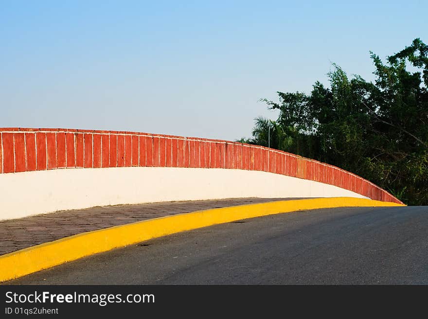 Colorful bridge leading towards trees