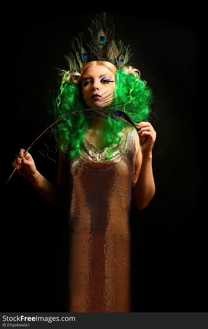 Girl-peacock in gold dress with green hairs