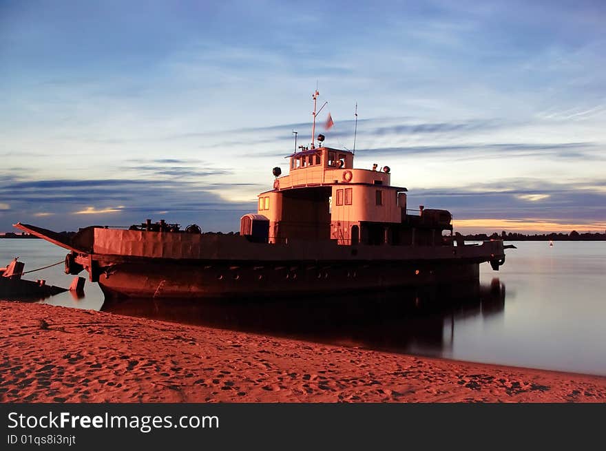 Ferry-boat at the twilight sand bank. Ferry-boat at the twilight sand bank