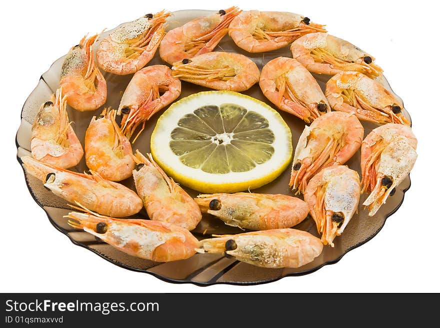 Plate with the sea Kamchatka shrimps stacked on a circle and a lemon