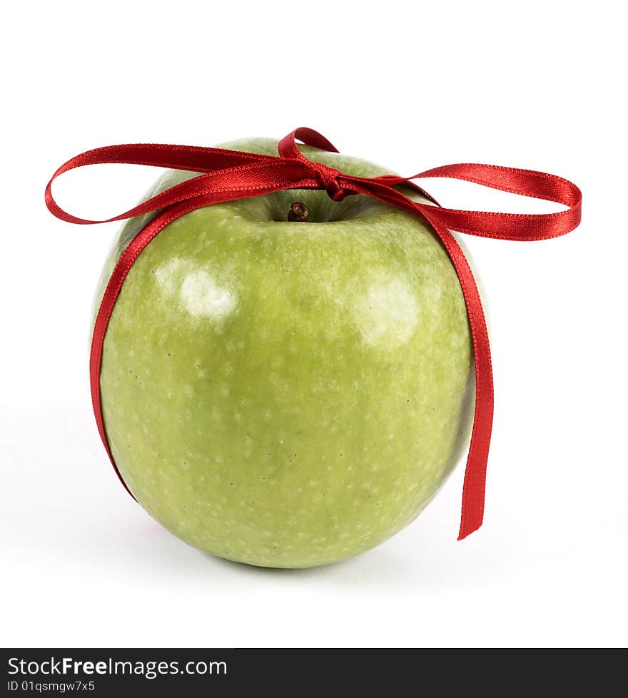 Green apple decorated with red ribbon. Green apple decorated with red ribbon