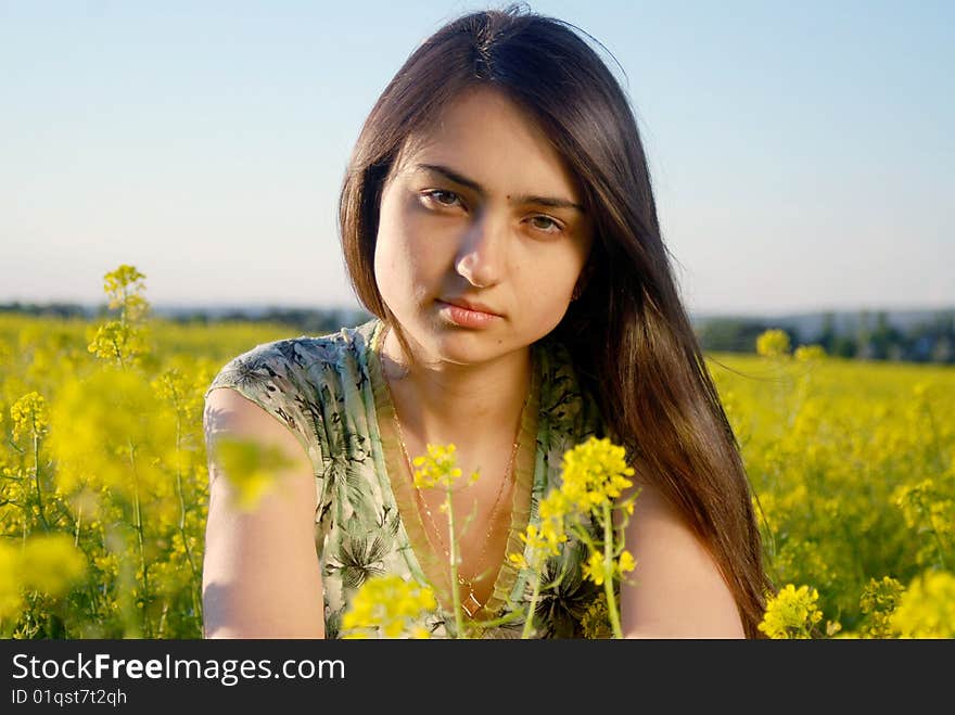 Girl on a yellow canola field