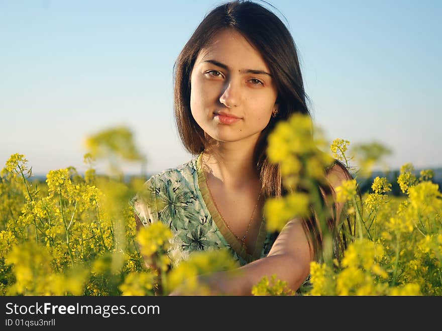 Girl on a yellow canola field