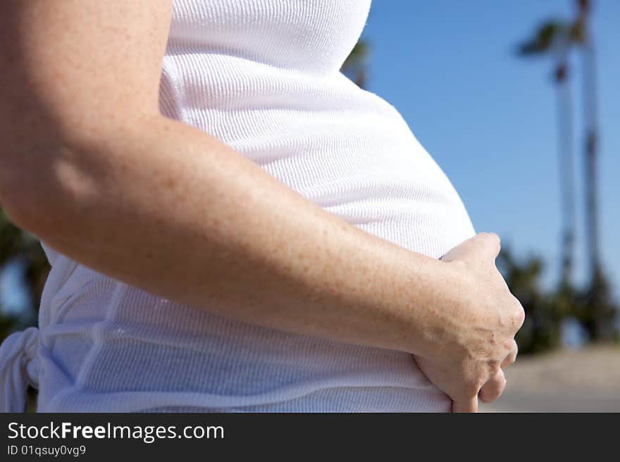 A Pregnant woman expecting a baby with a full belly