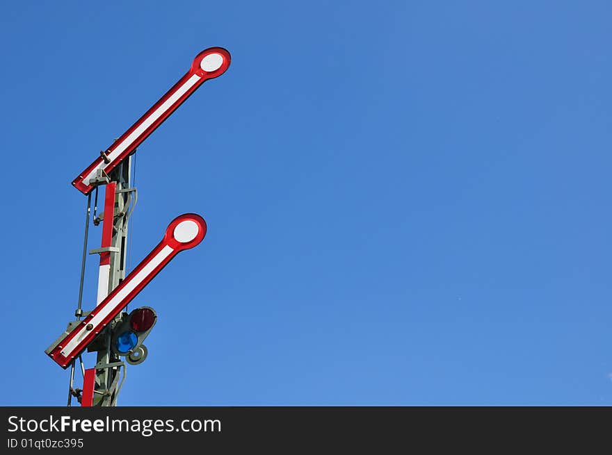 Old-fashioned train sign in front of blue sky