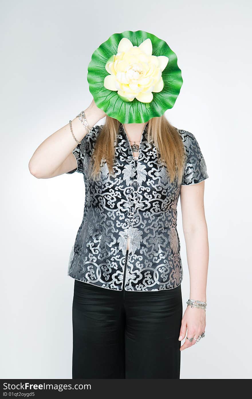 Woman with lotus flower, studio shot