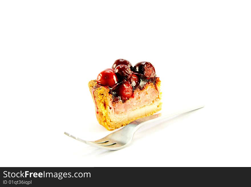 Slice of pork pie and a fork with clipping path on a white background. Slice of pork pie and a fork with clipping path on a white background