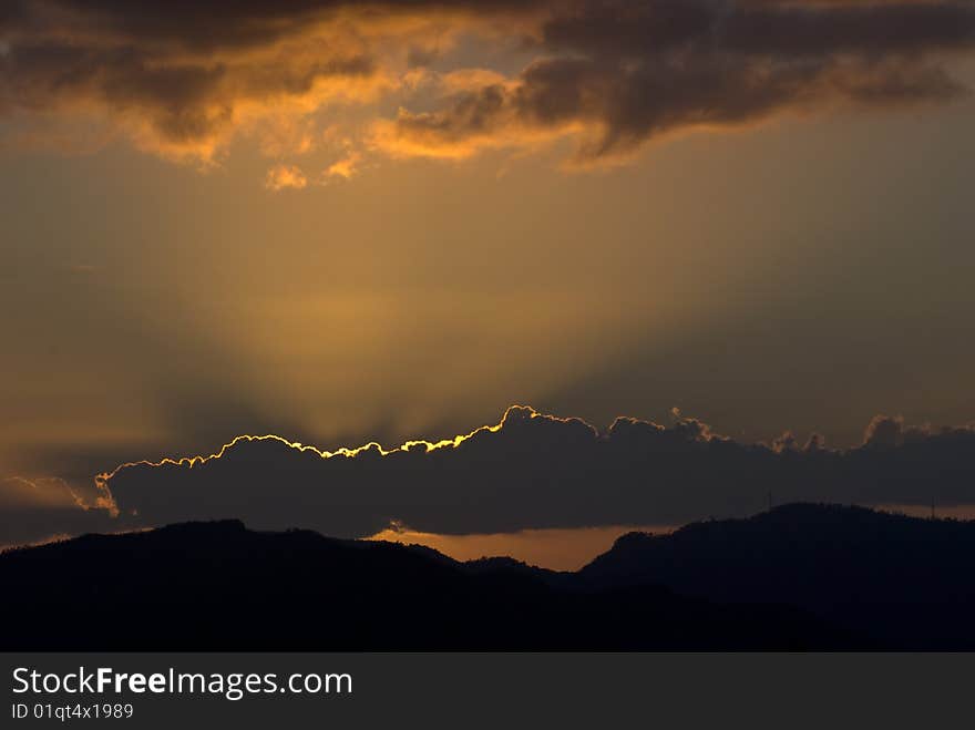 Sundown with sun behind a cloud. Sundown with sun behind a cloud