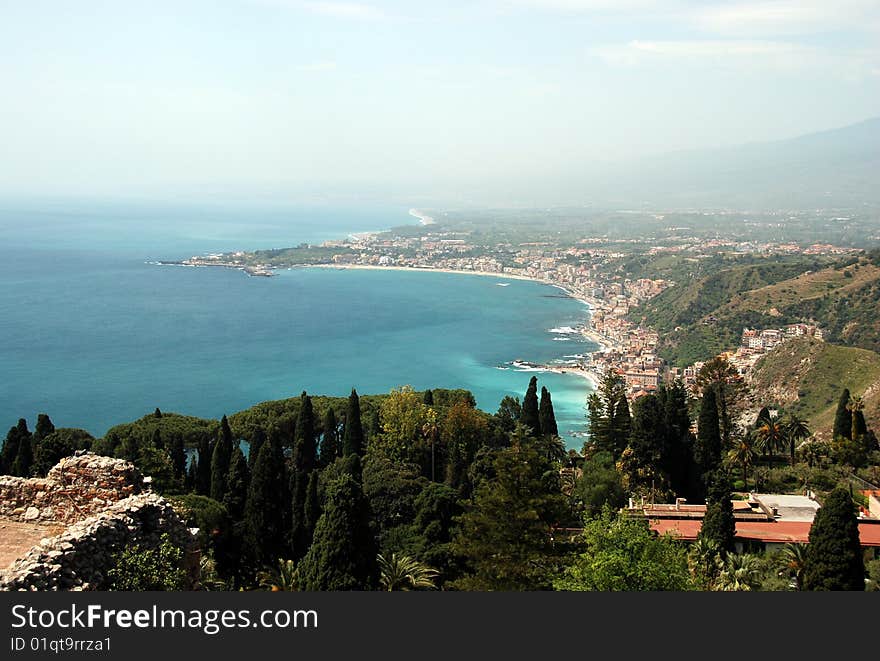 Bay with clear blue water in Taormina, coast of North Sicily, old towns and beautiful sea. Bay with clear blue water in Taormina, coast of North Sicily, old towns and beautiful sea.