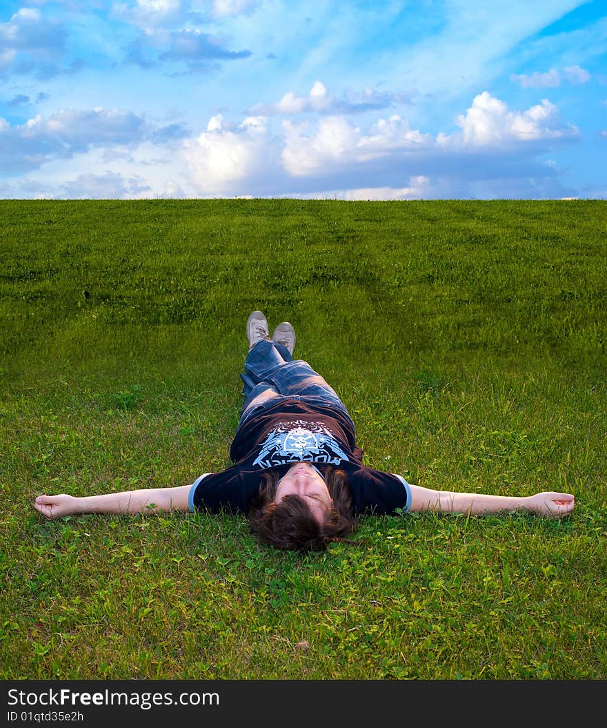 Young men on the meadow, green grass. Young men on the meadow, green grass