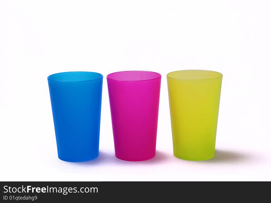 Three colorfull toothbrush holders on a white background