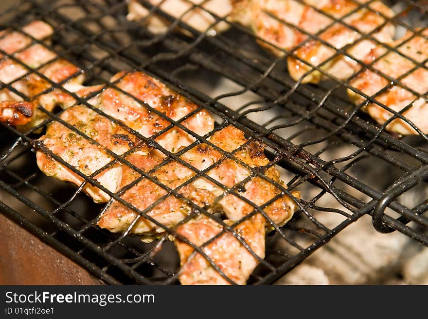 Shish kebab roasting on an open fire to background