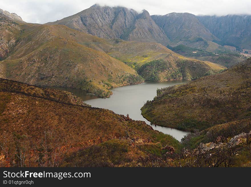 Mountain dam in the Villiersdorp area of South Africa, with burnt vegetation