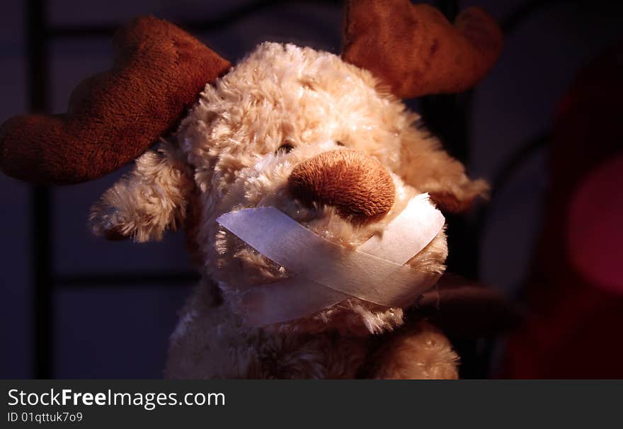 Restrained stuffed animal with ducktape on his mouth