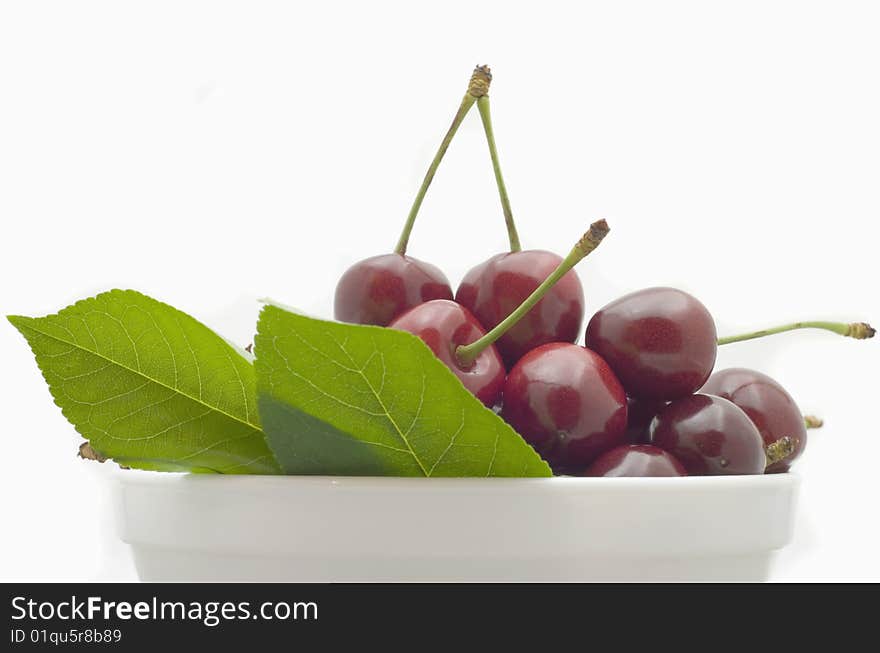 Berries red cherry in white bowl isolated on white background. Berries red cherry in white bowl isolated on white background