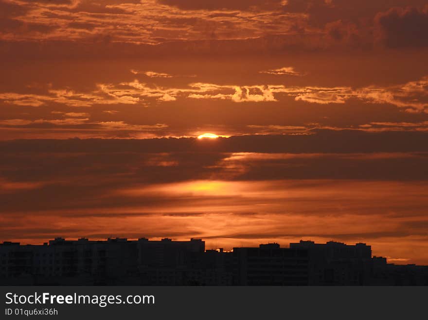 Bright red cloud sunset over the city