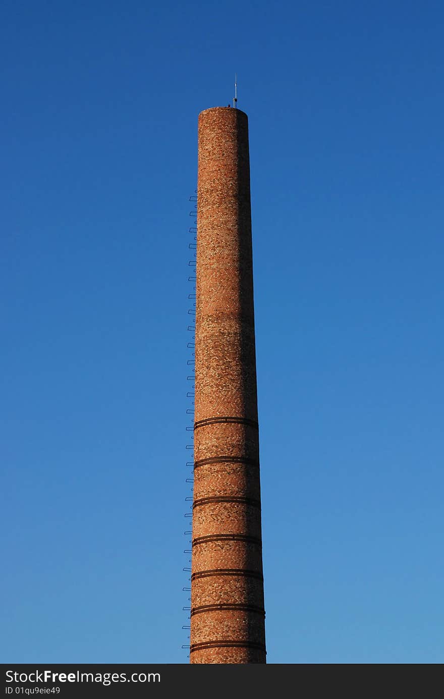 Red bricks pipe over blue sky. Red bricks pipe over blue sky