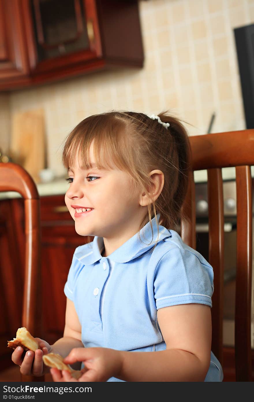 Portrait of a little girl on a kitchen at home. Portrait of a little girl on a kitchen at home.