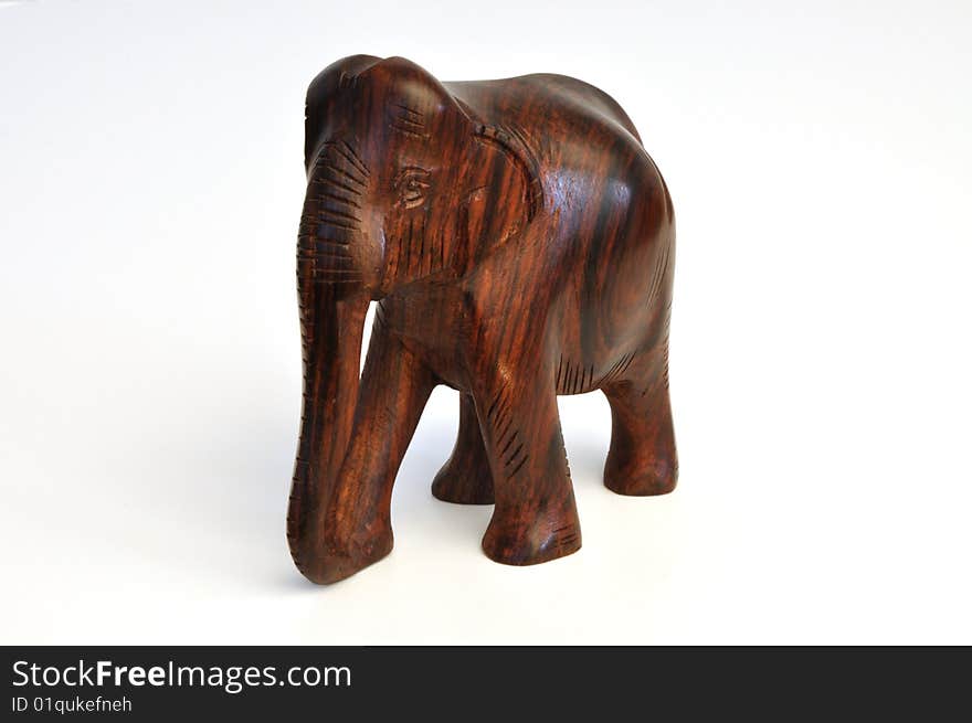 Hand-carved wooden elephant from India, facing center-left. Hand-carved wooden elephant from India, facing center-left