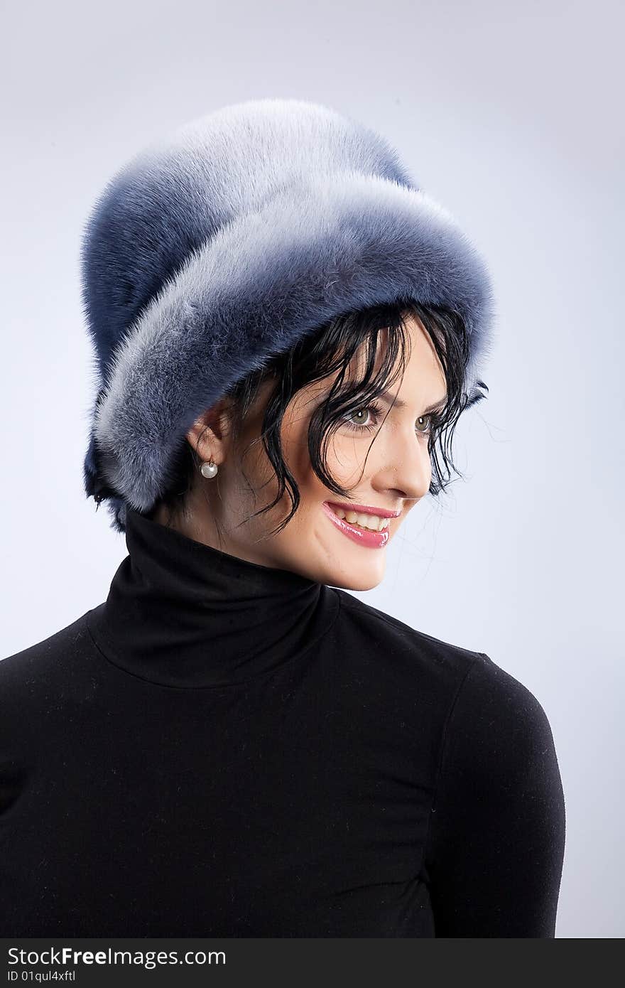 Young attractive woman in a fur hat