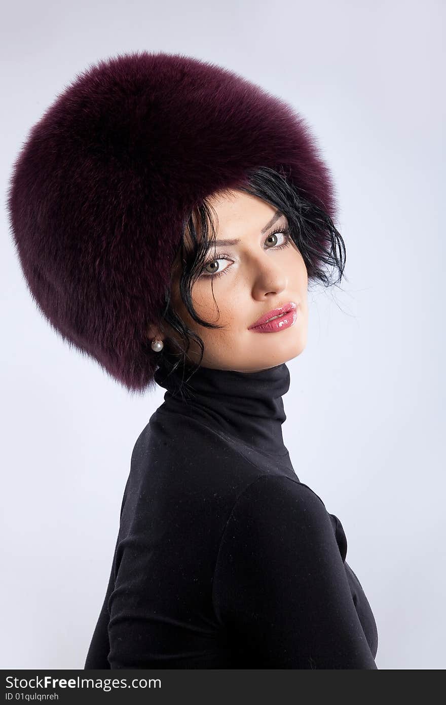 Young attractive woman in a fur hat