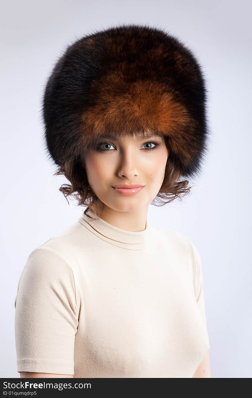 Young attractive woman in a fur hat