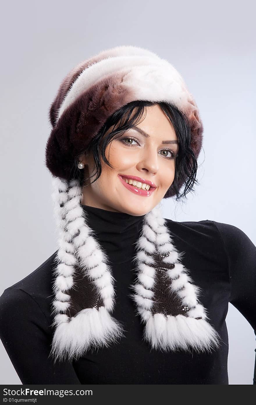 Young attractive woman in a fur hat