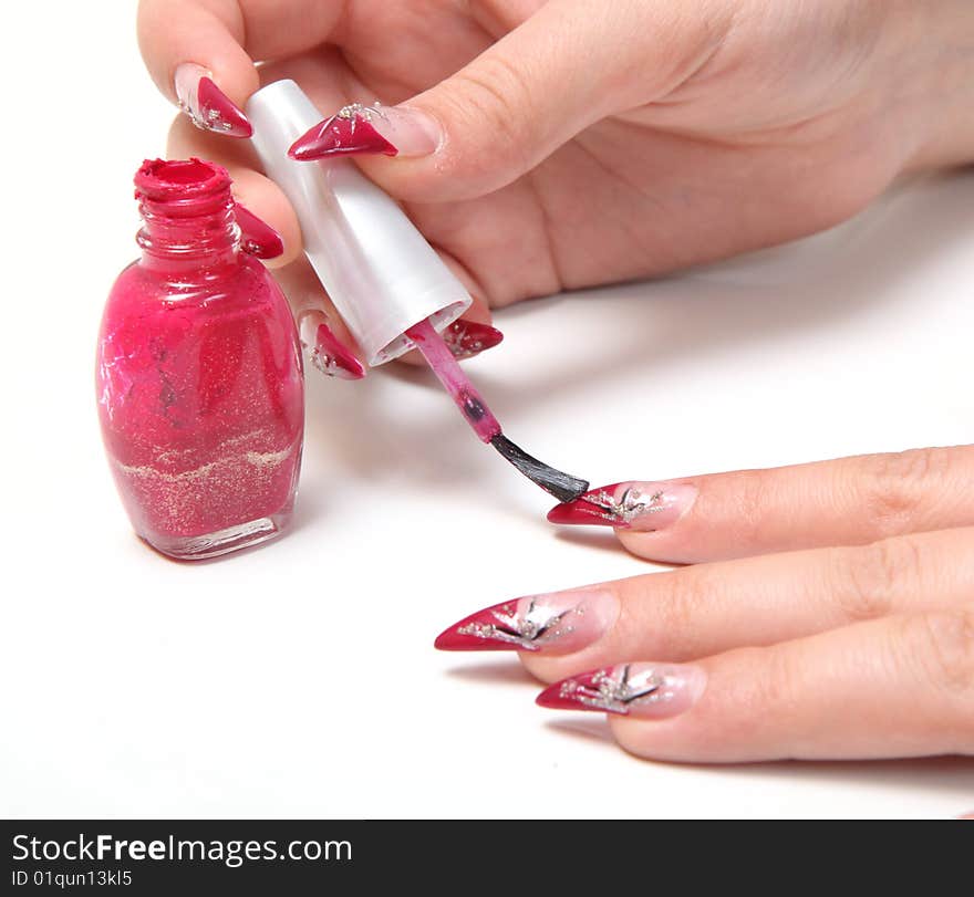 Woman applying red nail polish. Woman applying red nail polish