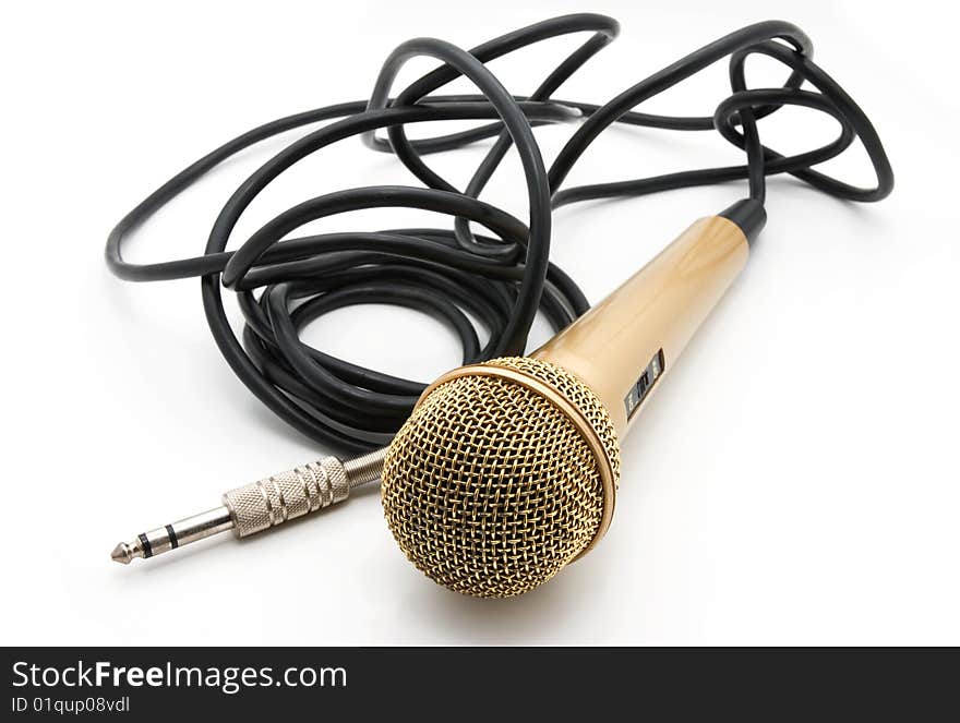 Old golden microphone with a black wire