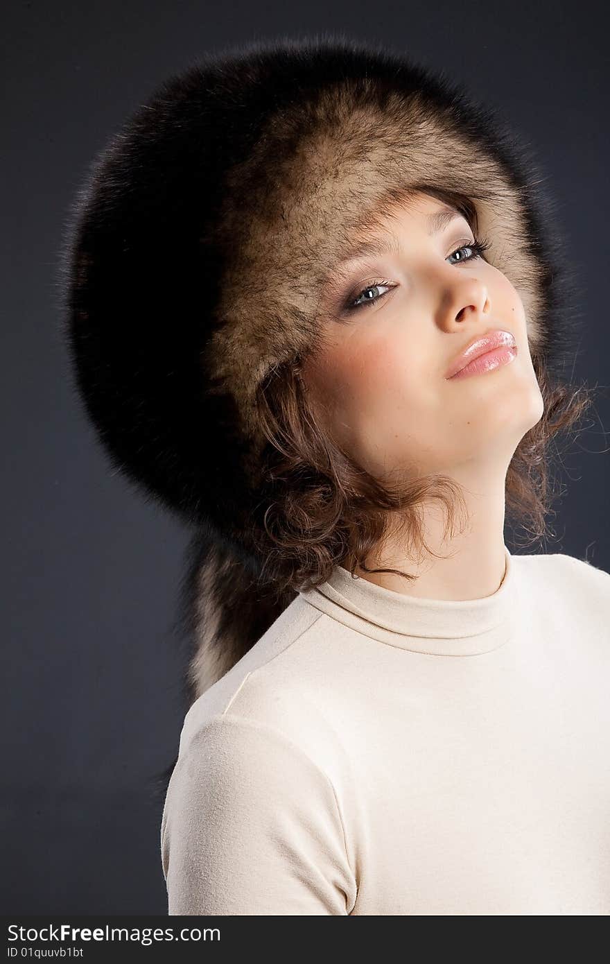 Young attractive woman in a fur hat