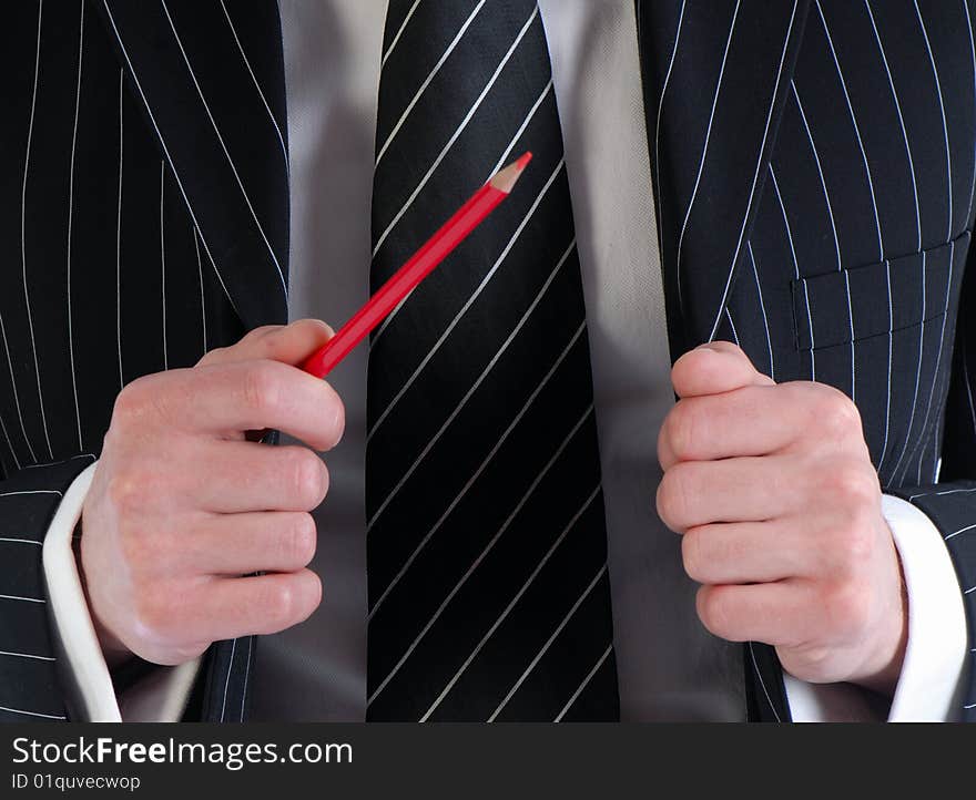 Businessman gesticulates with  pencil in  hand on  background of  suit