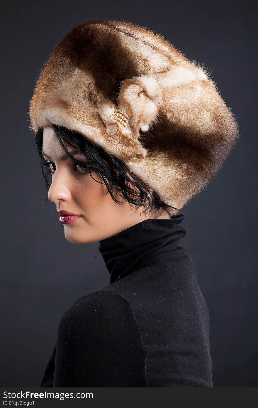 Young attractive woman in a fur hat