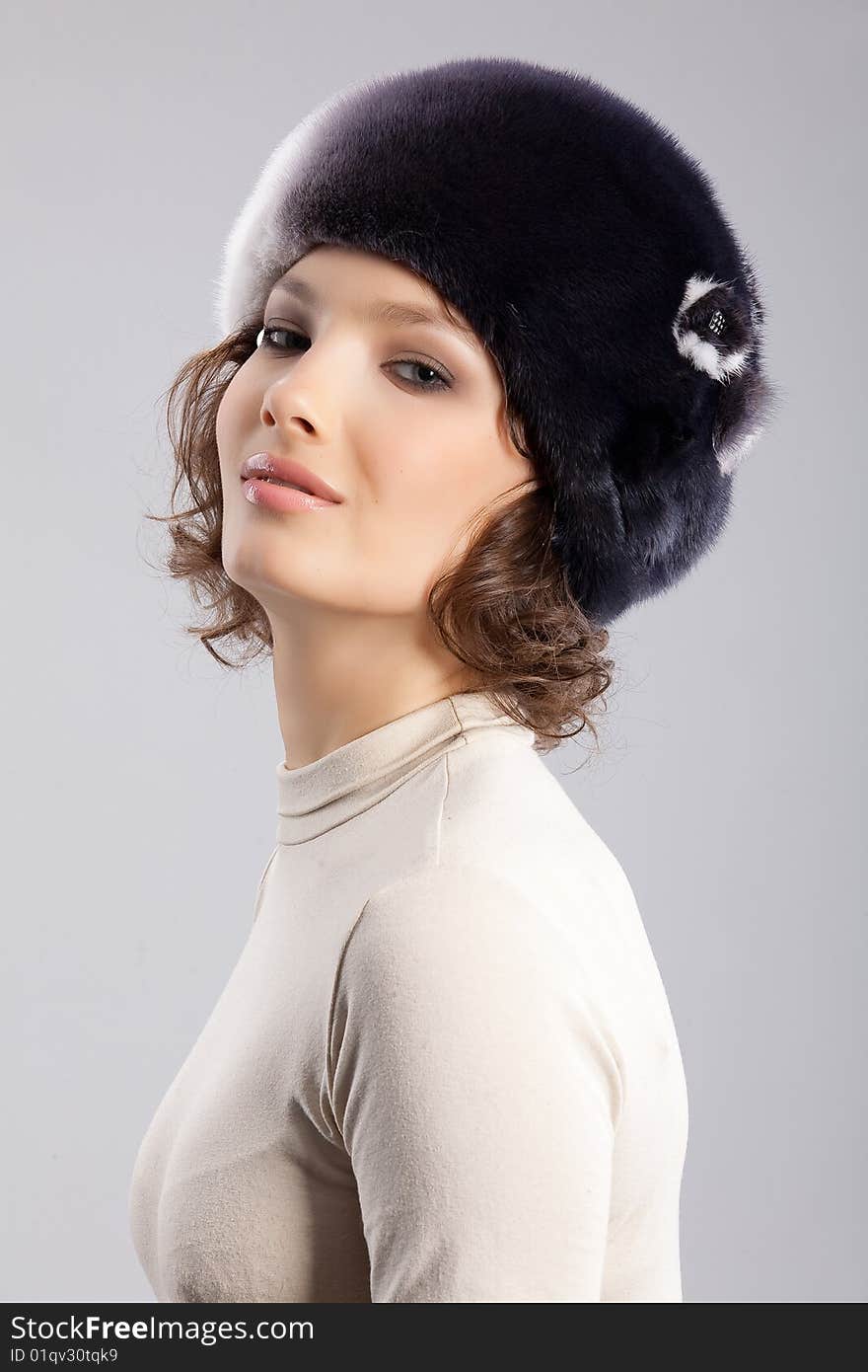 Young attractive woman in a fur hat