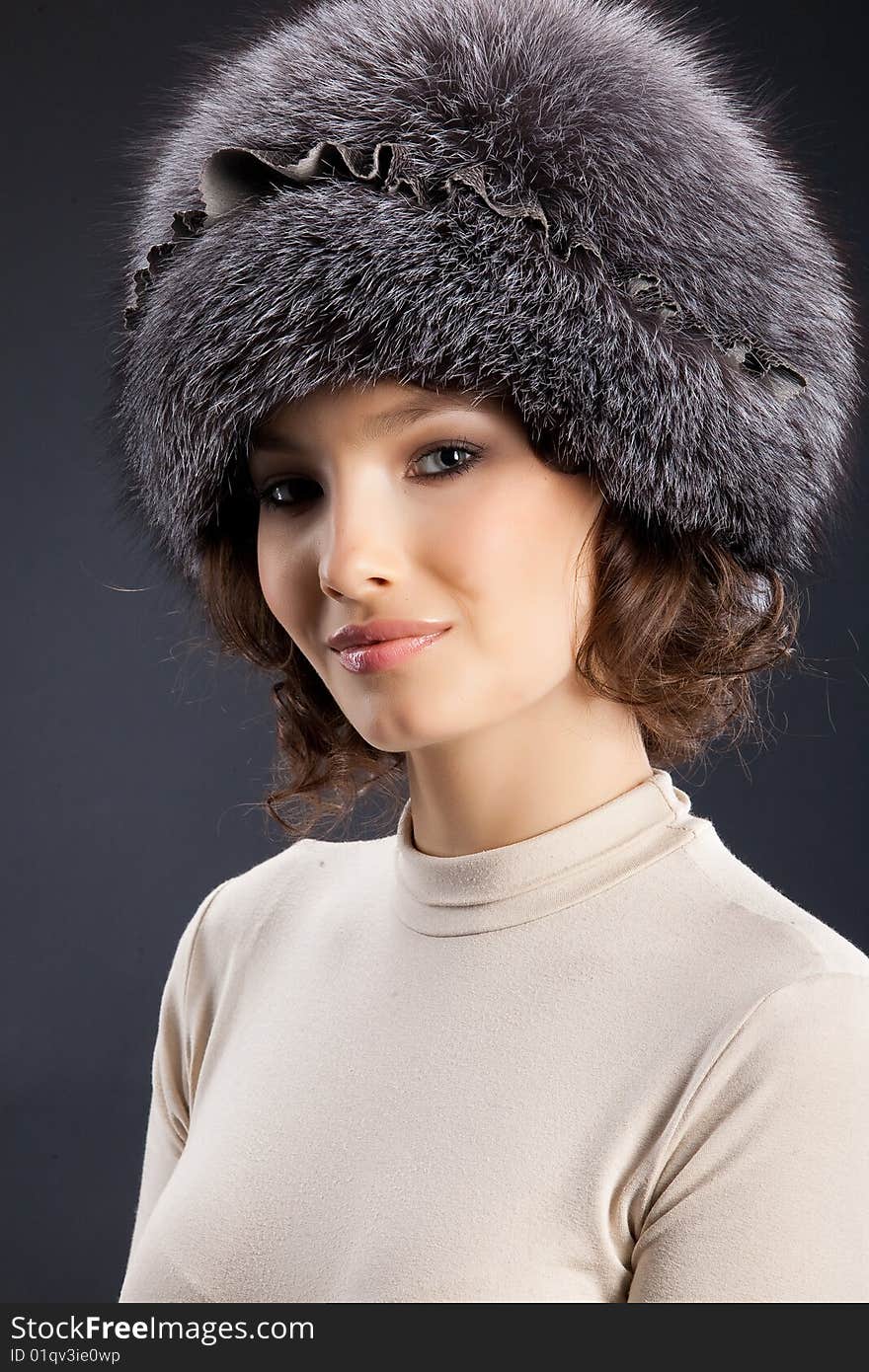 Young attractive woman in a fur hat