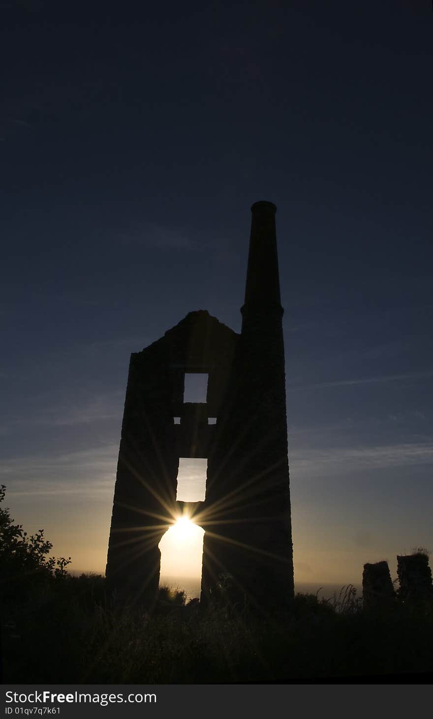 Sun setting behind the ruin of a cornish tin mine. Sun setting behind the ruin of a cornish tin mine