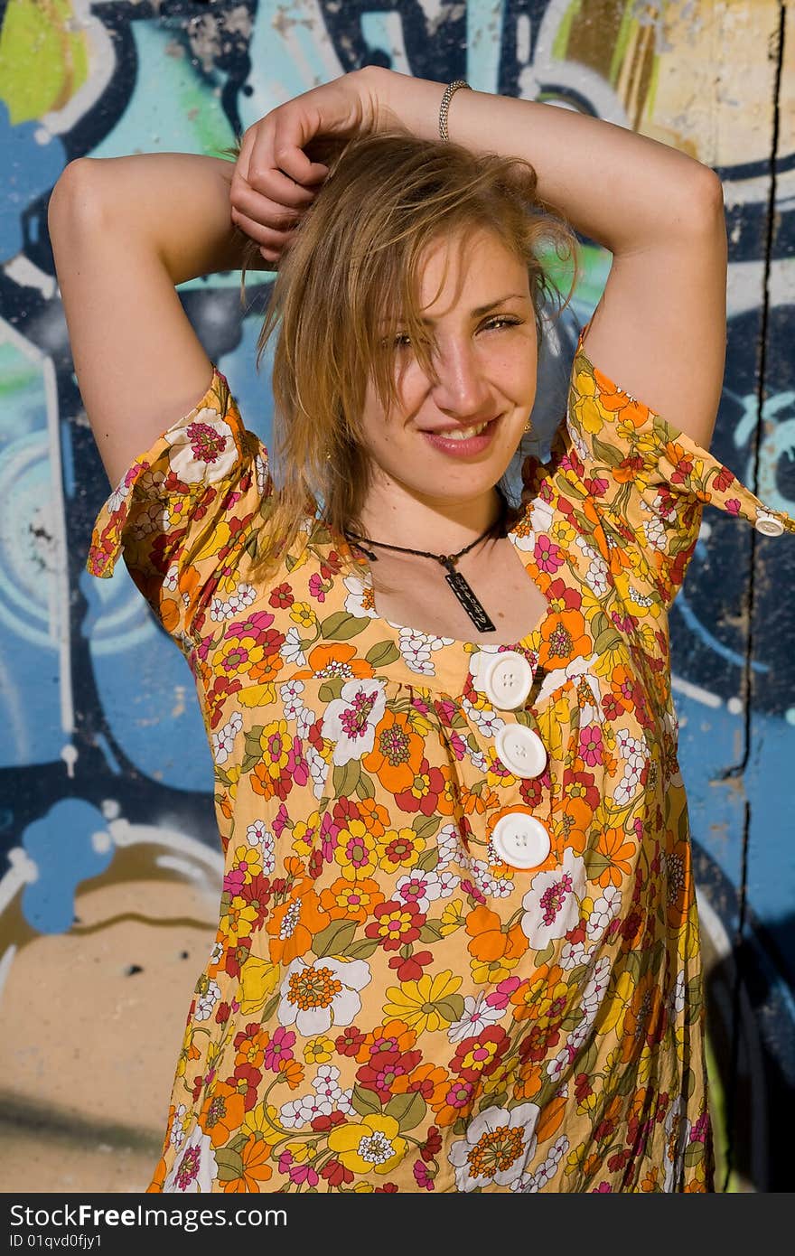 Young urbans girl poses  a wall with graffiti. Young urbans girl poses  a wall with graffiti