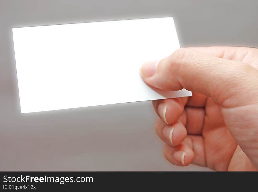 Paper card in woman hand grey background