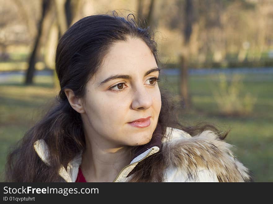 Young girl looking at the distance in the park