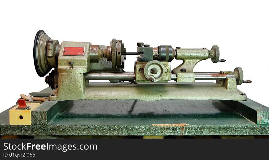 Зortable lathe on green board isolated