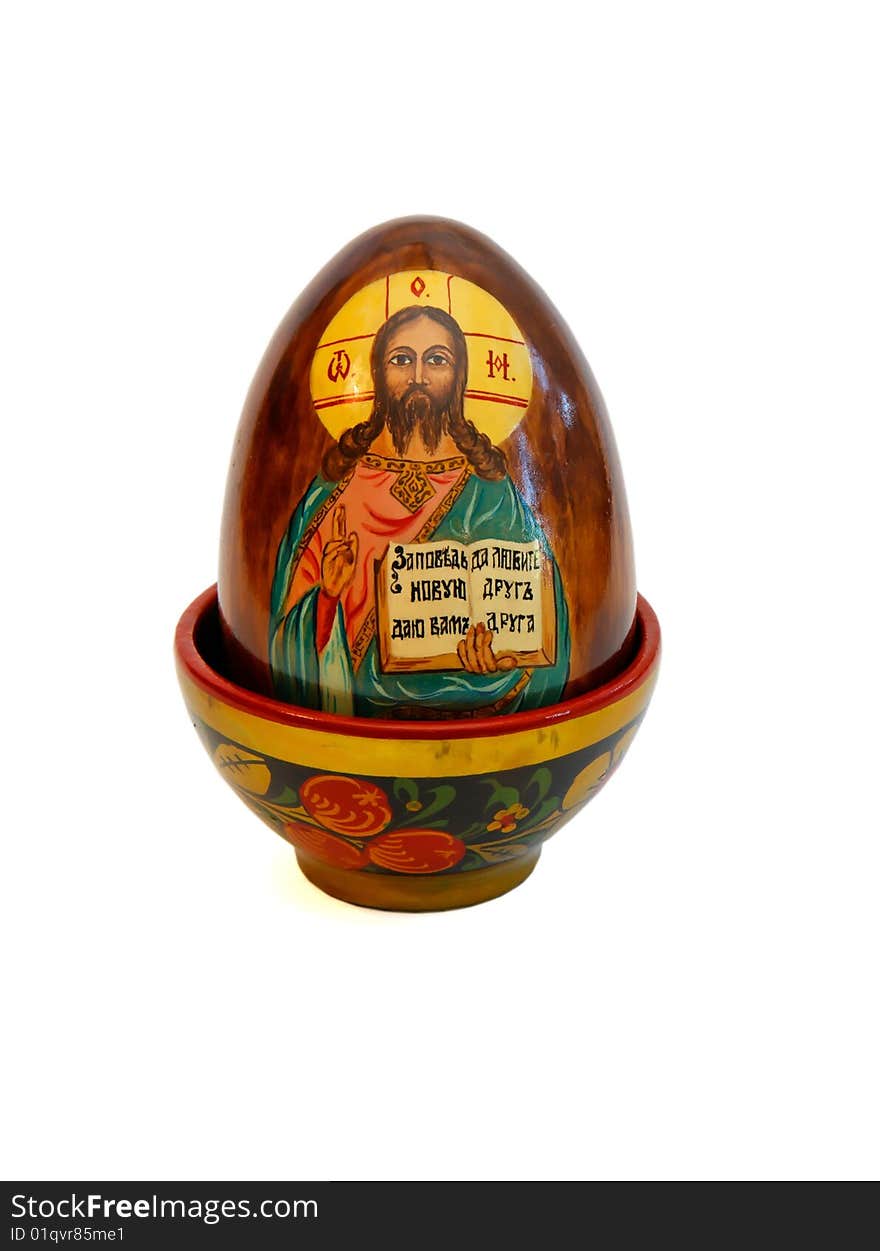 Russian easter egg with Jesus Christ in wooden cup on white background. Russian easter egg with Jesus Christ in wooden cup on white background