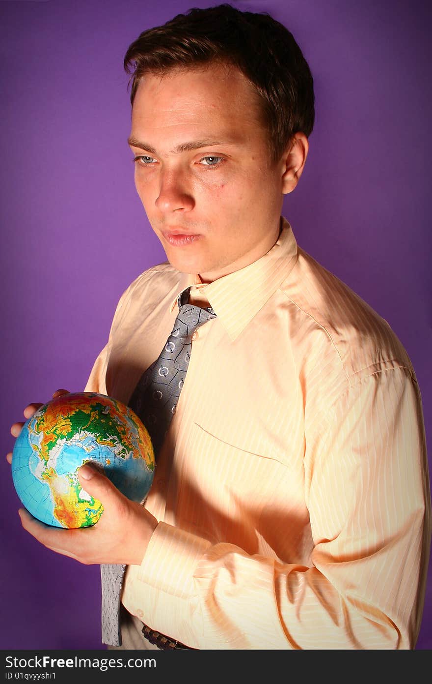 Young businessman standing with globe in his hands. Young businessman standing with globe in his hands