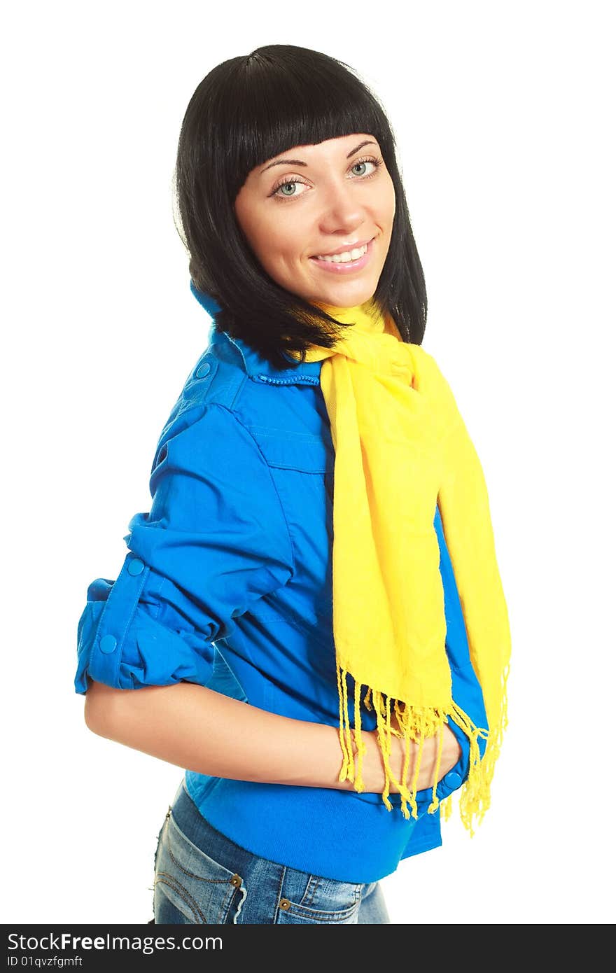 Portrait of a beautiful young brunette woman wearing a blue jacket and a yellow scarf